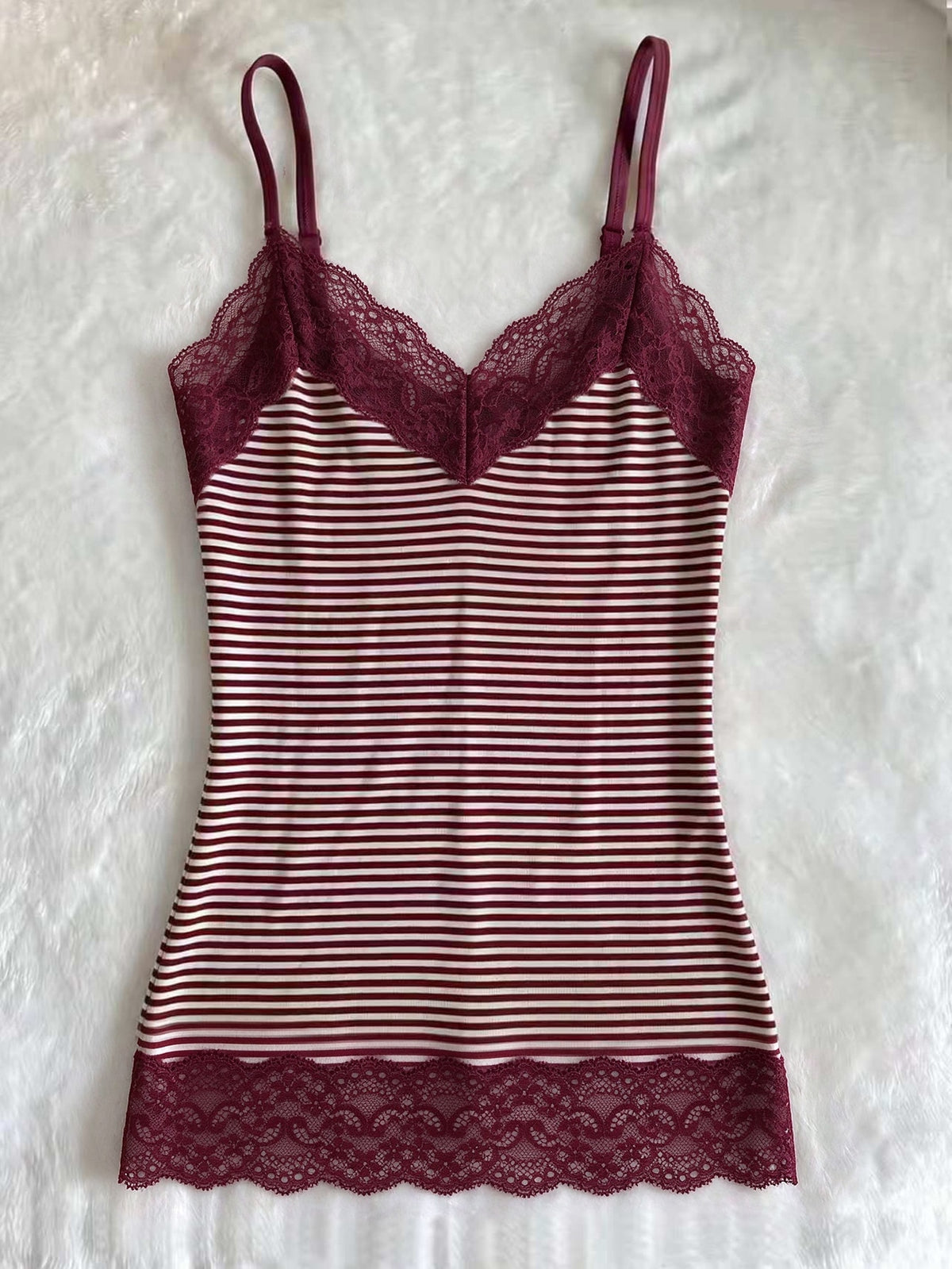 Women's solid color slim fit camisole top featuring delicate lace patchwork embroidery and tank straps.