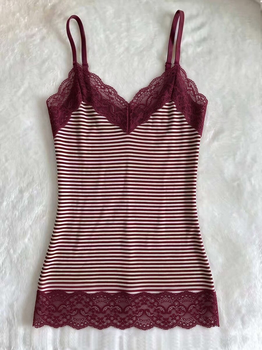 Women's solid color slim fit camisole top featuring delicate lace patchwork embroidery and tank straps.