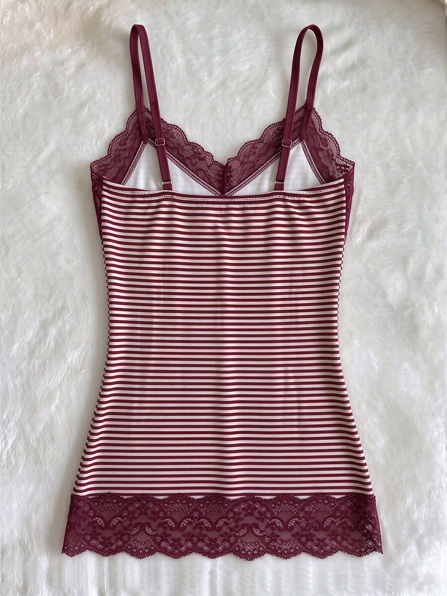 Women's solid color slim fit camisole top featuring delicate lace patchwork embroidery and tank straps.