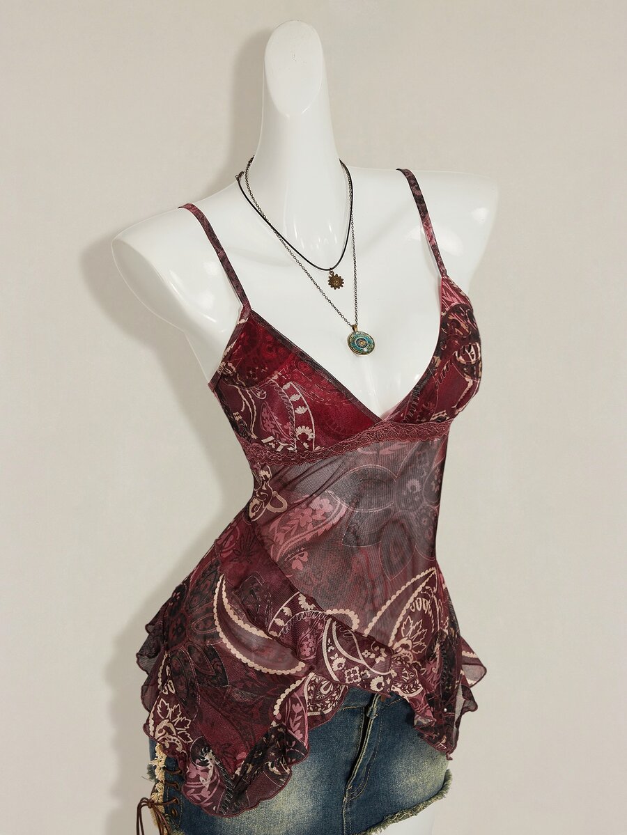 Women's burgundy floral graphic print mesh camisole top featuring an asymmetrical hem, backless cut, and spaghetti straps.
