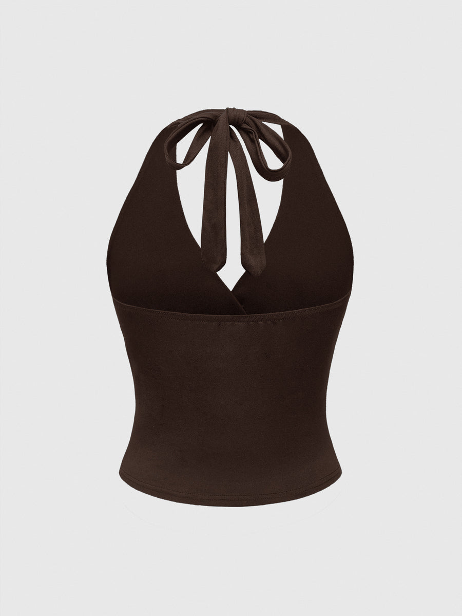 Women's halter crop tank top featuring a backless silhouette and ruched detailing in a slim fit design.