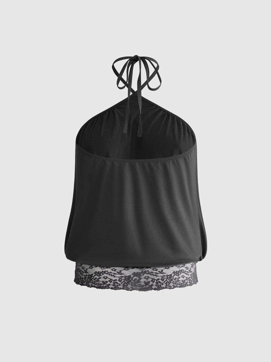 Woman wearing a black slim fit halter camisole crop top with lace-up backless tie detail.