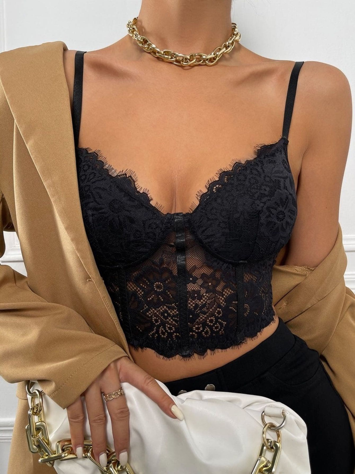 Women wearing a black lace bustier crop cami top with spaghetti straps and slim fit corset detailing.