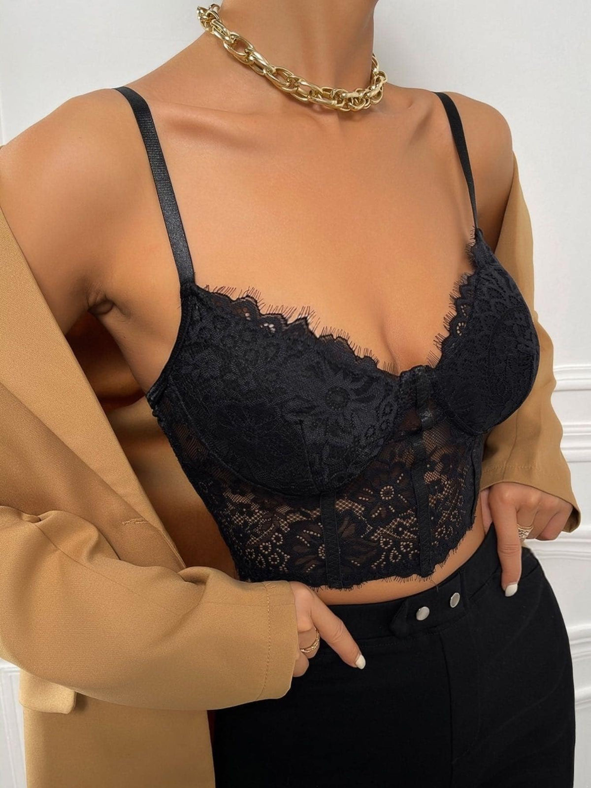 Women wearing a black lace bustier crop cami top with spaghetti straps and slim fit corset detailing.