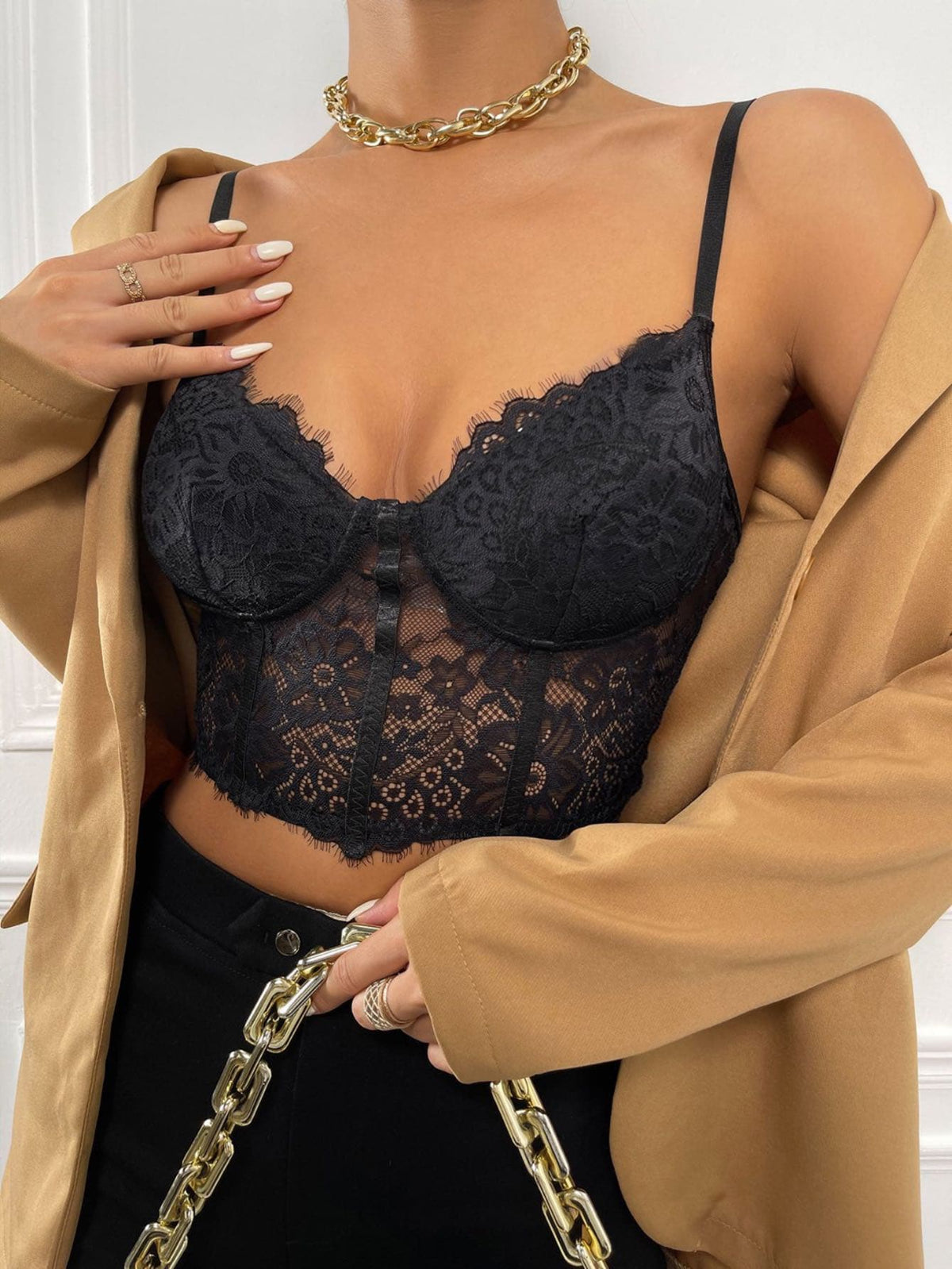 Women wearing a black lace bustier crop cami top with spaghetti straps and slim fit corset detailing.