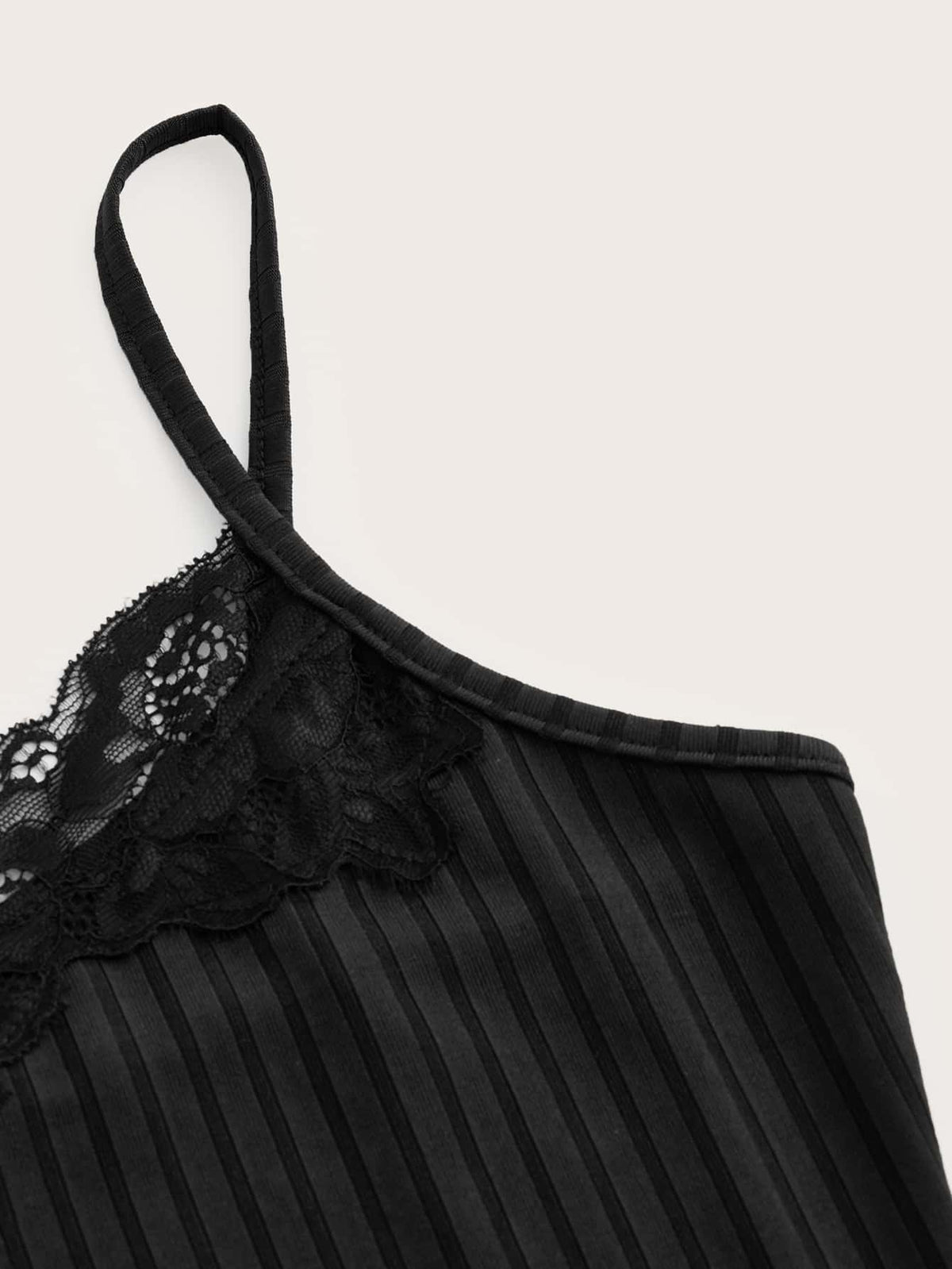 Women's black rib-knit cami top featuring delicate contrast lace trim and thin spaghetti straps.