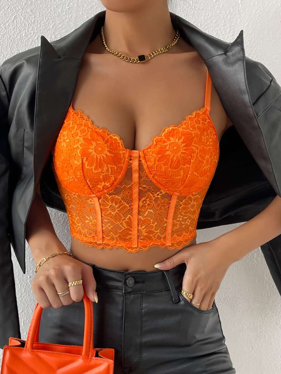 Women wearing a black lace bustier crop cami top with spaghetti straps and slim fit corset detailing.