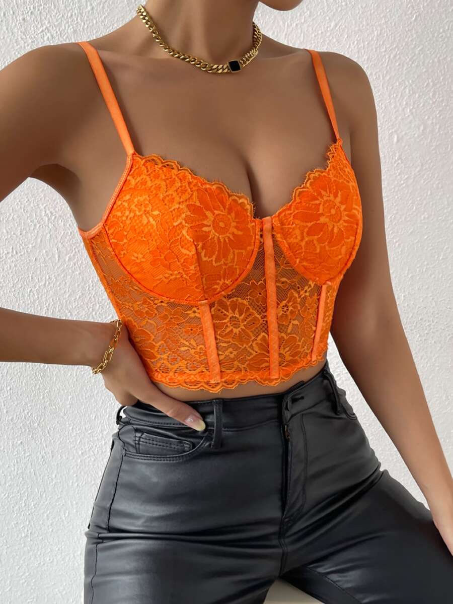 Women wearing a black lace bustier crop cami top with spaghetti straps and slim fit corset detailing.