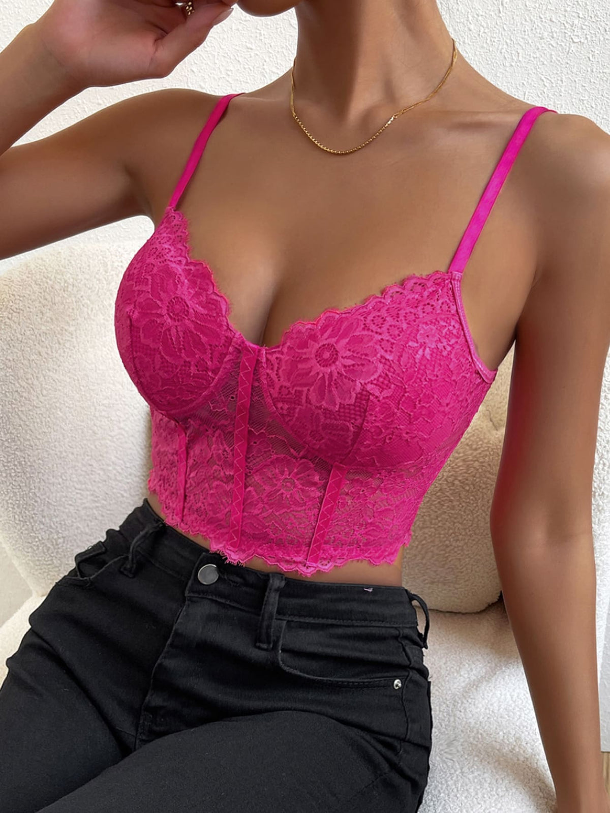 Women wearing a black lace bustier crop cami top with spaghetti straps and slim fit corset detailing.