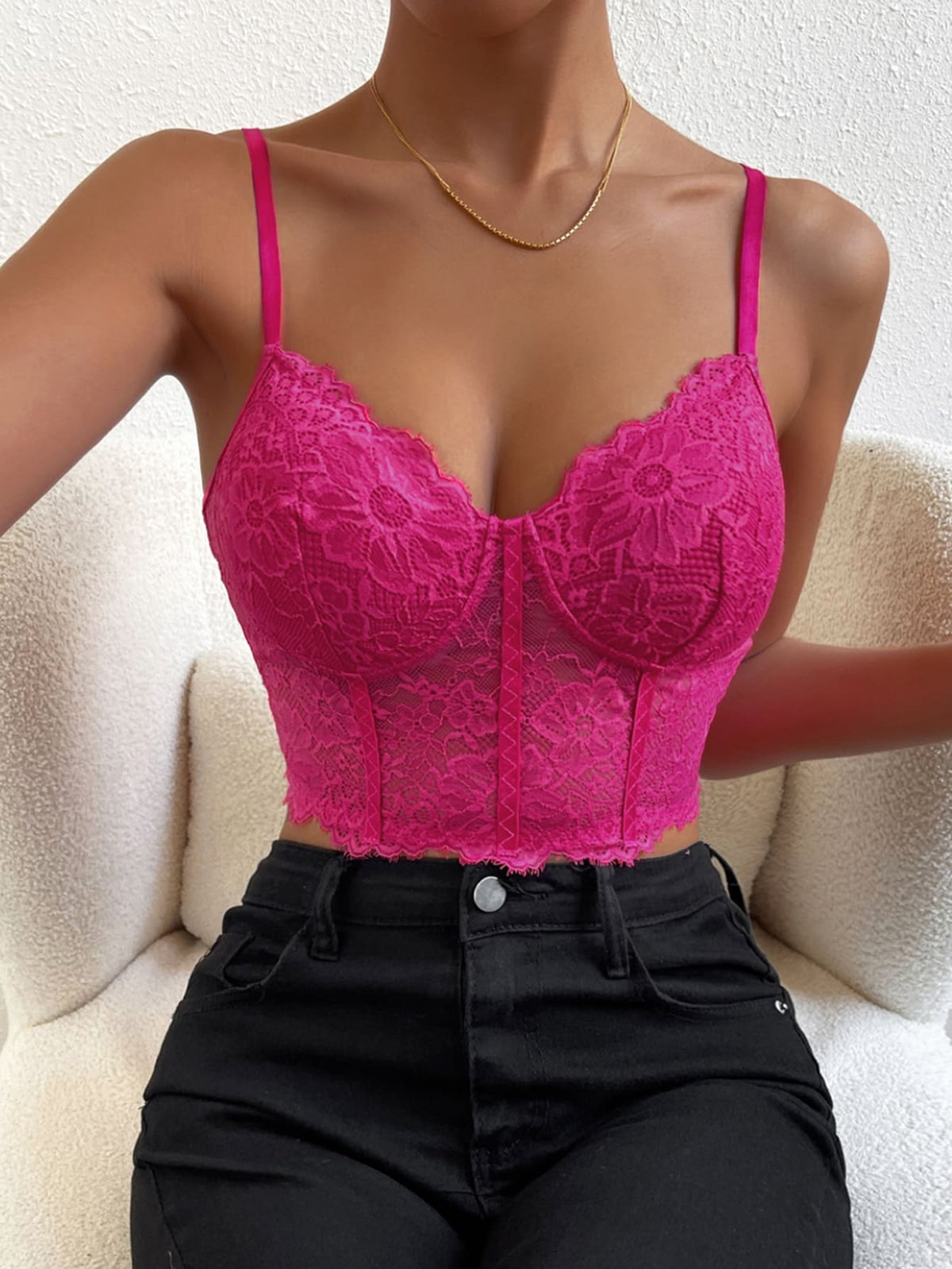 Women wearing a black lace bustier crop cami top with spaghetti straps and slim fit corset detailing.
