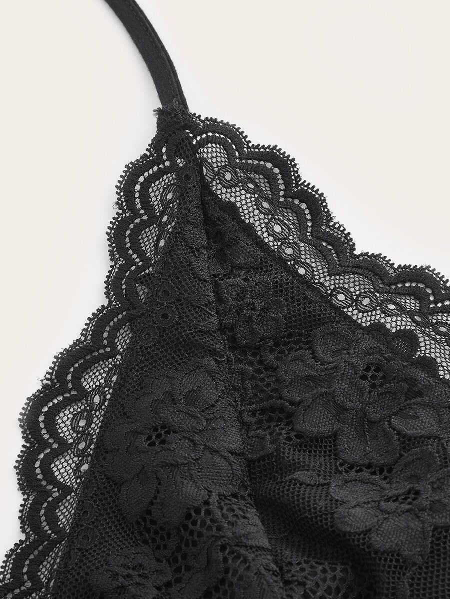 A women's black backless halter top featuring contrast lace trim, ruched front detail, and slim fit soft knitted fabric.