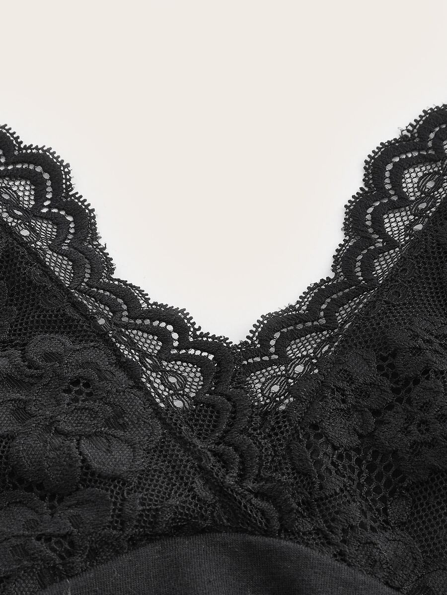 A women's black backless halter top featuring contrast lace trim, ruched front detail, and slim fit soft knitted fabric.