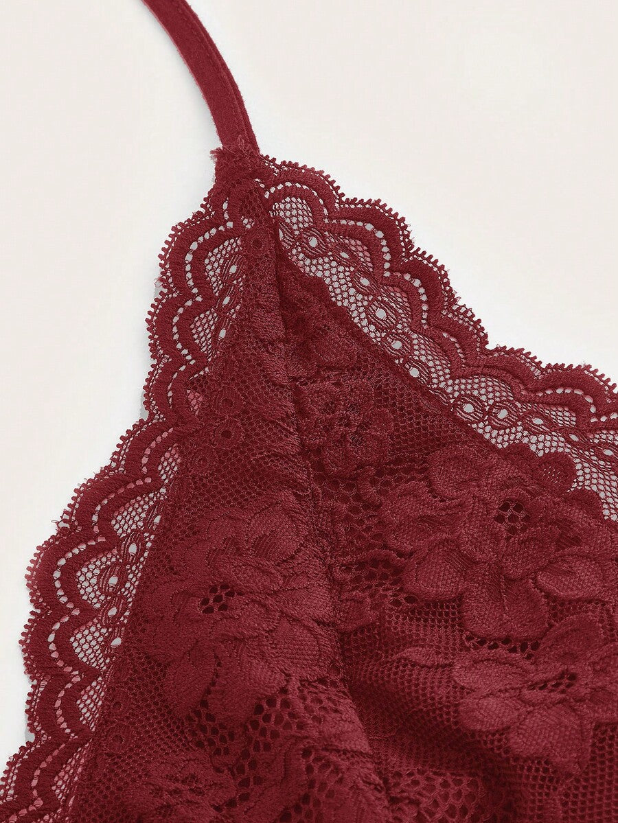 A women's black backless halter top featuring contrast lace trim, ruched front detail, and slim fit soft knitted fabric.