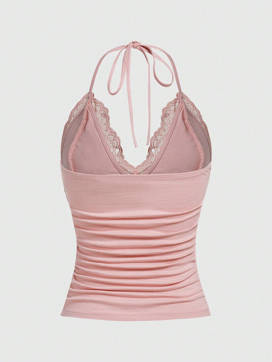 A women's black backless halter top featuring contrast lace trim, ruched front detail, and slim fit soft knitted fabric.