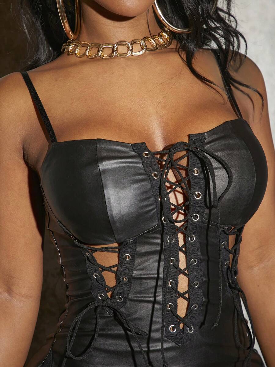 Women's black PU cami mini dress featuring spaghetti straps, backless lace-up grommet eyelet detail, high waist, and slim fit silhouette.