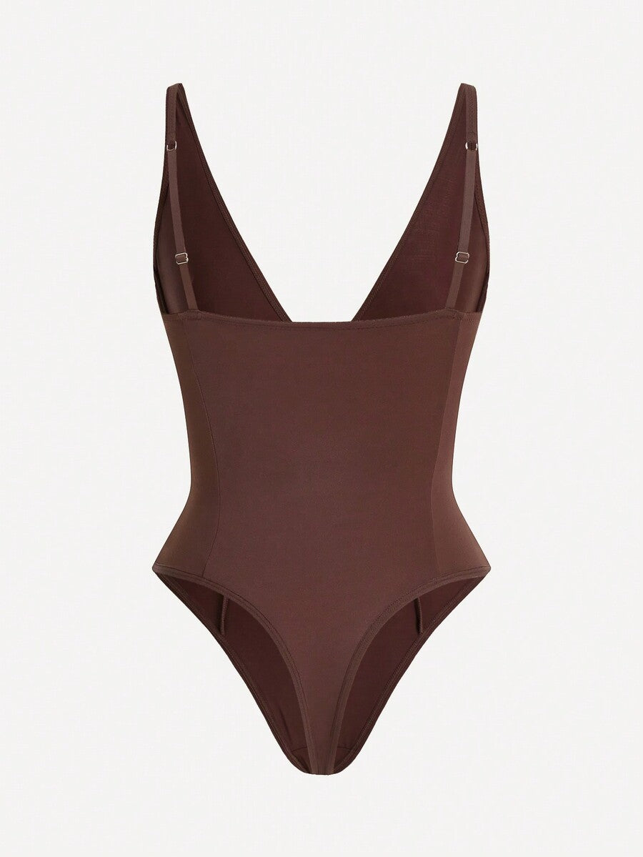 Apricot backless shapewear bodysuit with thong cut, cup details, and high-stretch fabric for light tummy support.