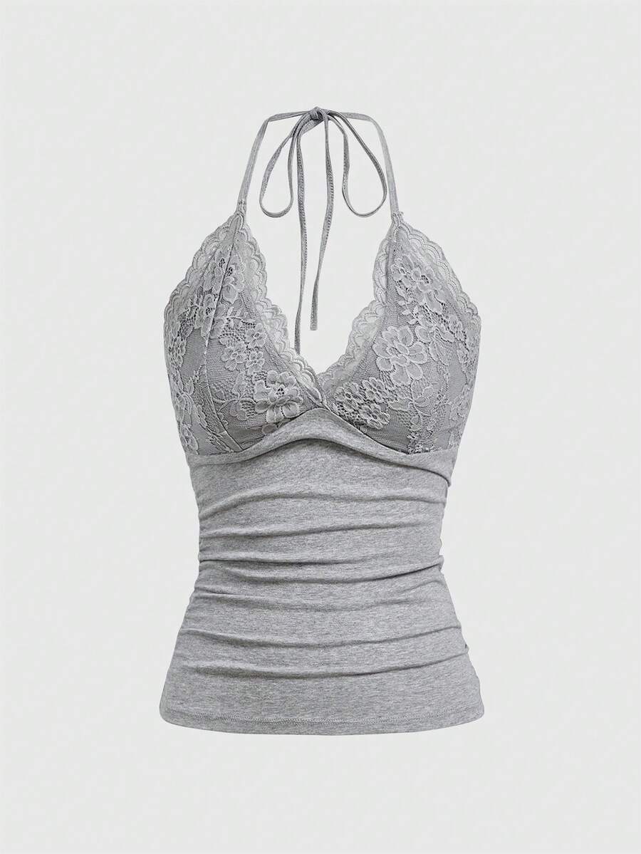 A women's black backless halter top featuring contrast lace trim, ruched front detail, and slim fit soft knitted fabric.