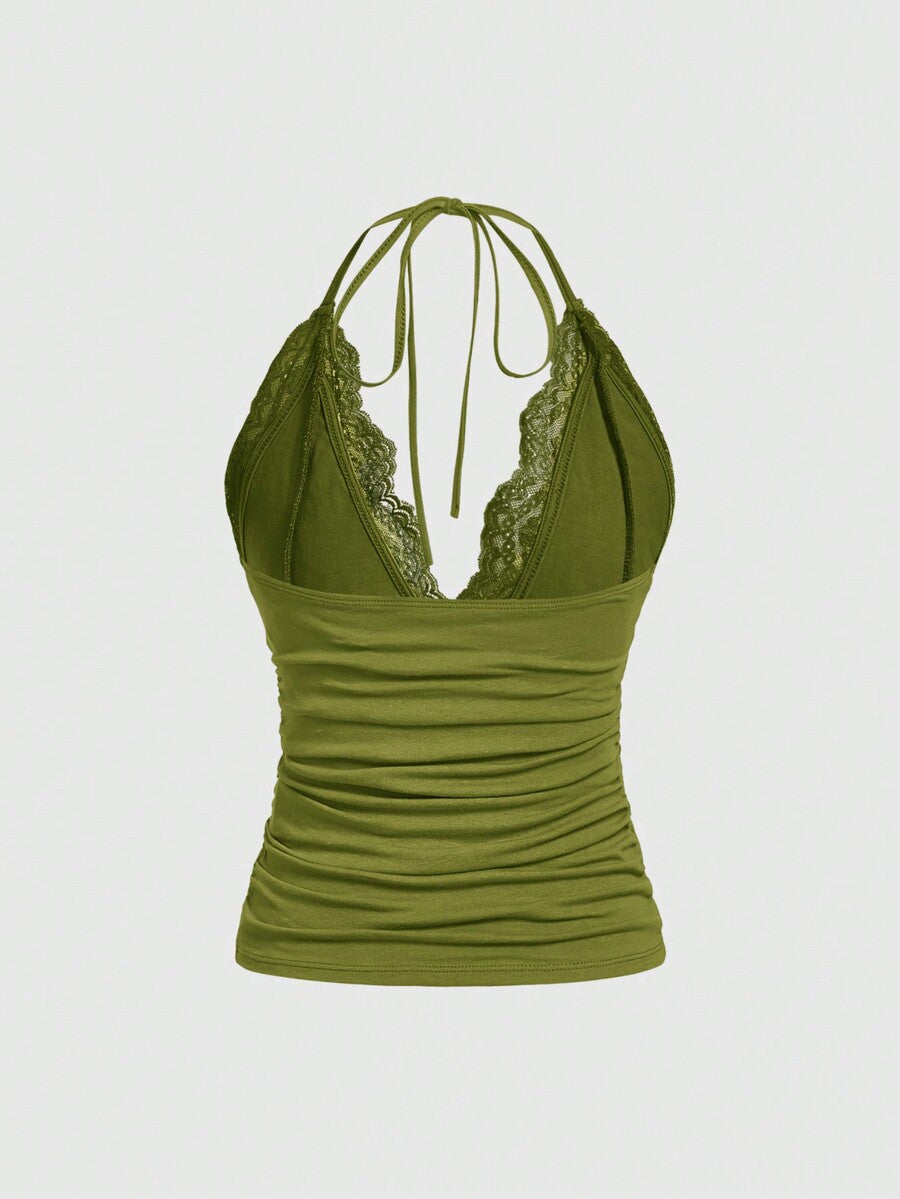 A women's black backless halter top featuring contrast lace trim, ruched front detail, and slim fit soft knitted fabric.