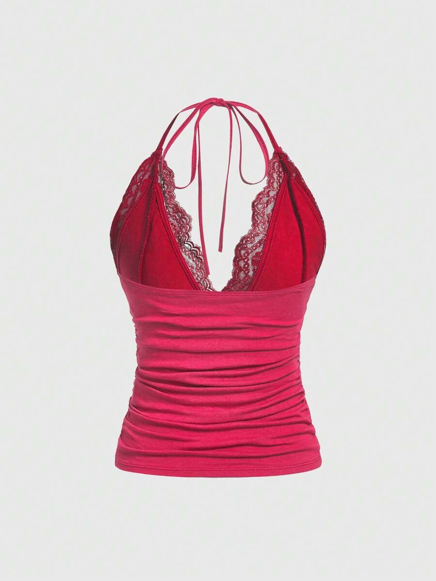 A women's black backless halter top featuring contrast lace trim, ruched front detail, and slim fit soft knitted fabric.