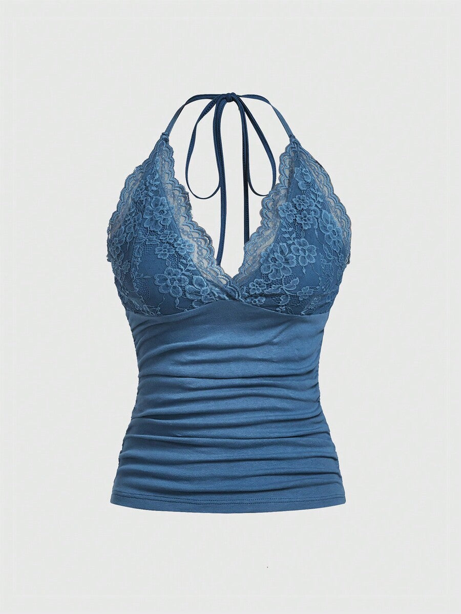 A women's black backless halter top featuring contrast lace trim, ruched front detail, and slim fit soft knitted fabric.