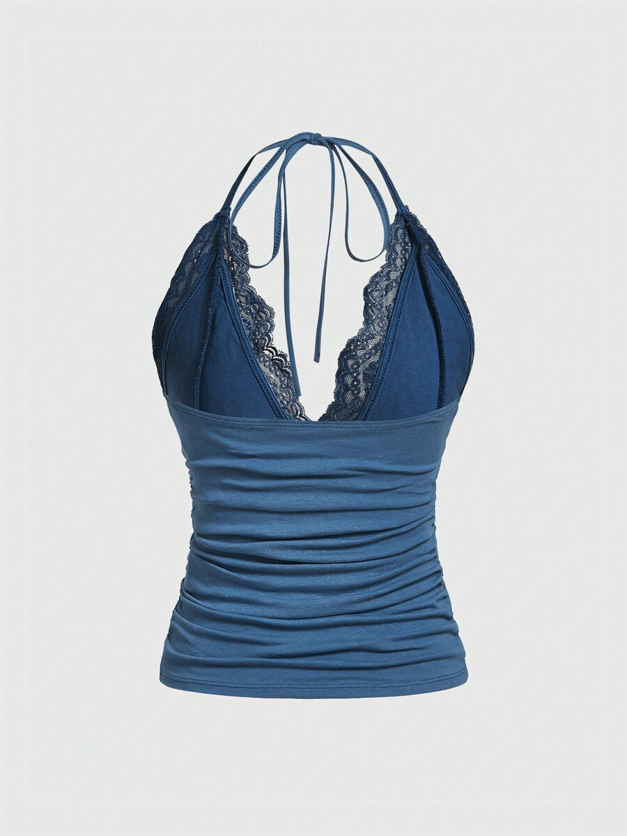 A women's black backless halter top featuring contrast lace trim, ruched front detail, and slim fit soft knitted fabric.