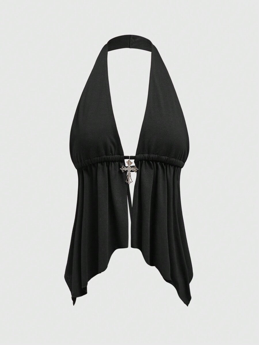 A women wearing a black halter crop top with a shiny rhinestone cross pendant, neck strap, backless cut, and asymmetrical ring detail.