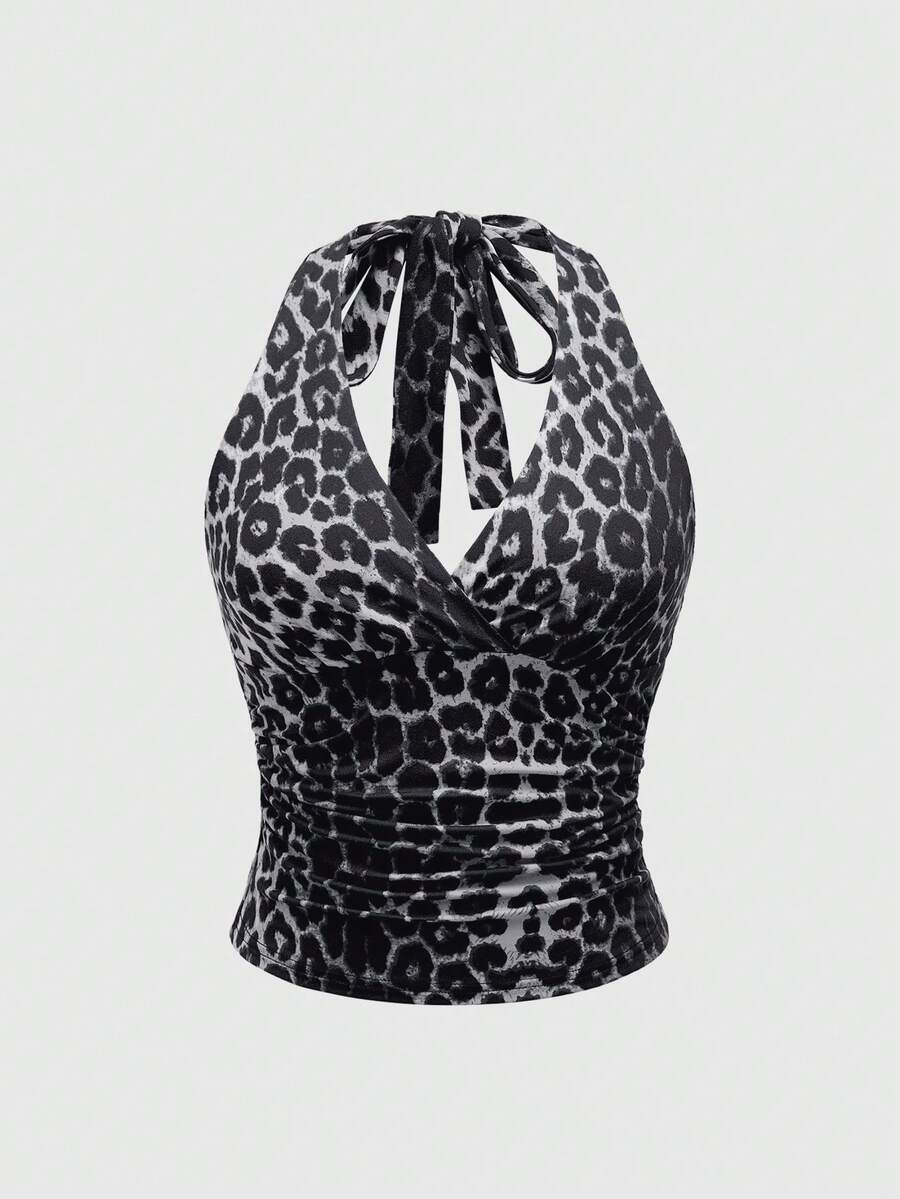 Women's halter crop tank top featuring a backless silhouette and ruched detailing in a slim fit design.