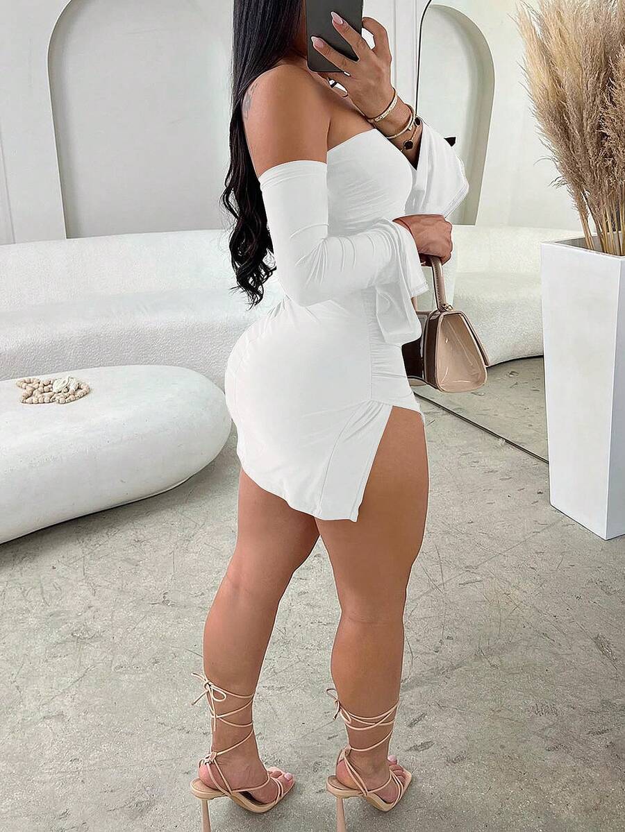 White off-the-shoulder sleeveless bodycon mini dress featuring ruched details, backless design, and asymmetrical high-split hem.