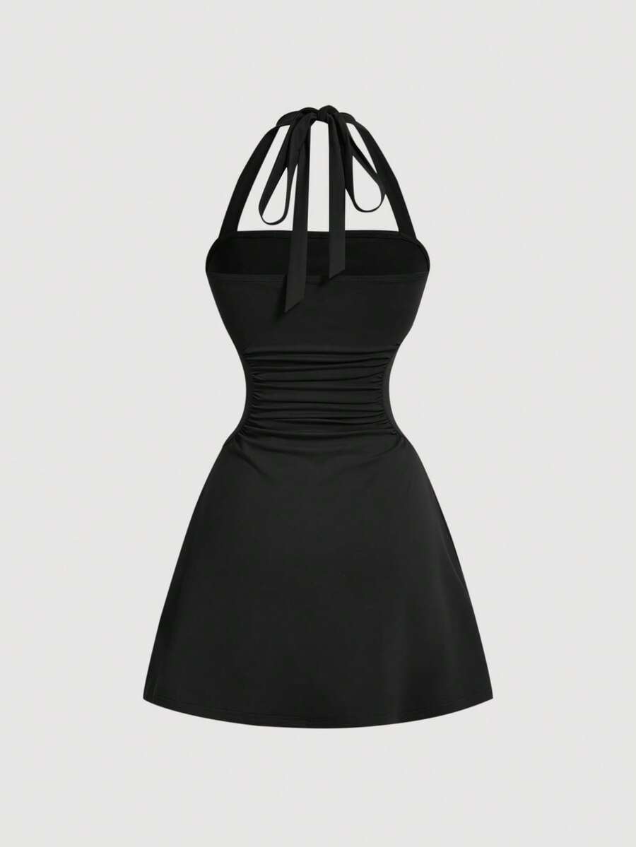 Women's black sleeveless halter neck A-line mini dress featuring backless ruched knot details and slim fit stretch knit fabric.