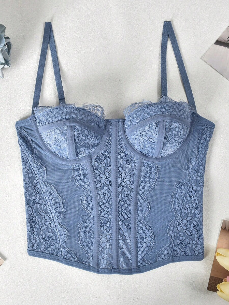 Black lace bustier corset top for women with asymmetrical contrast lace, lace-up detail, sleeveless crop cut, and light support.