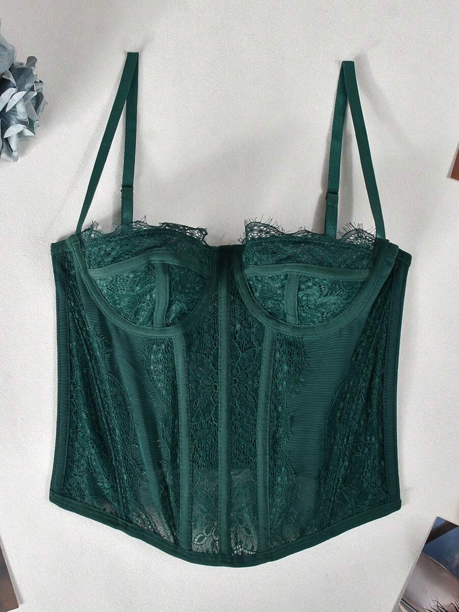 Black lace bustier corset top for women with asymmetrical contrast lace, lace-up detail, sleeveless crop cut, and light support.