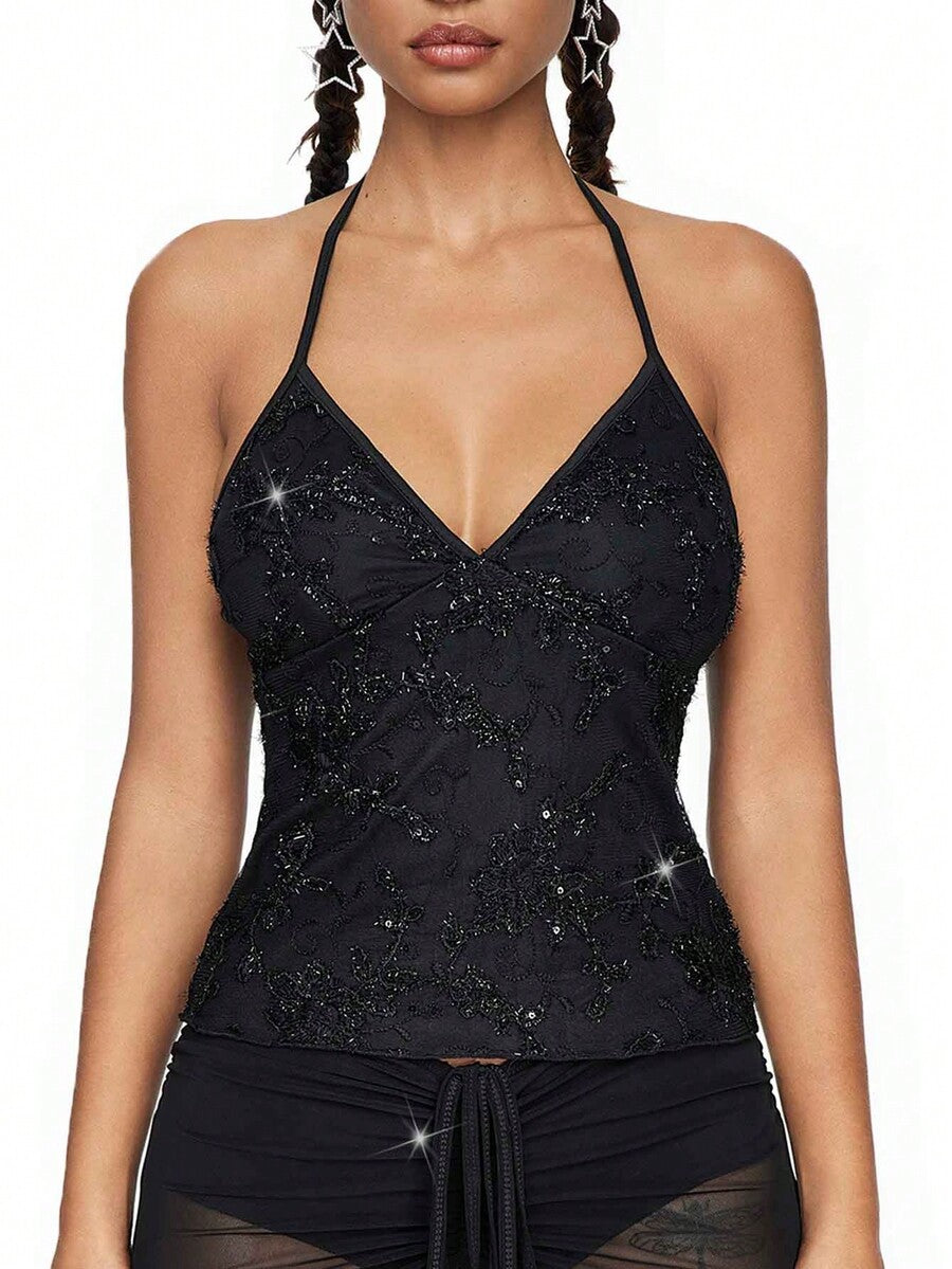 Women's black mesh sequin halter top featuring a backless design, knot details, and lace fabric.