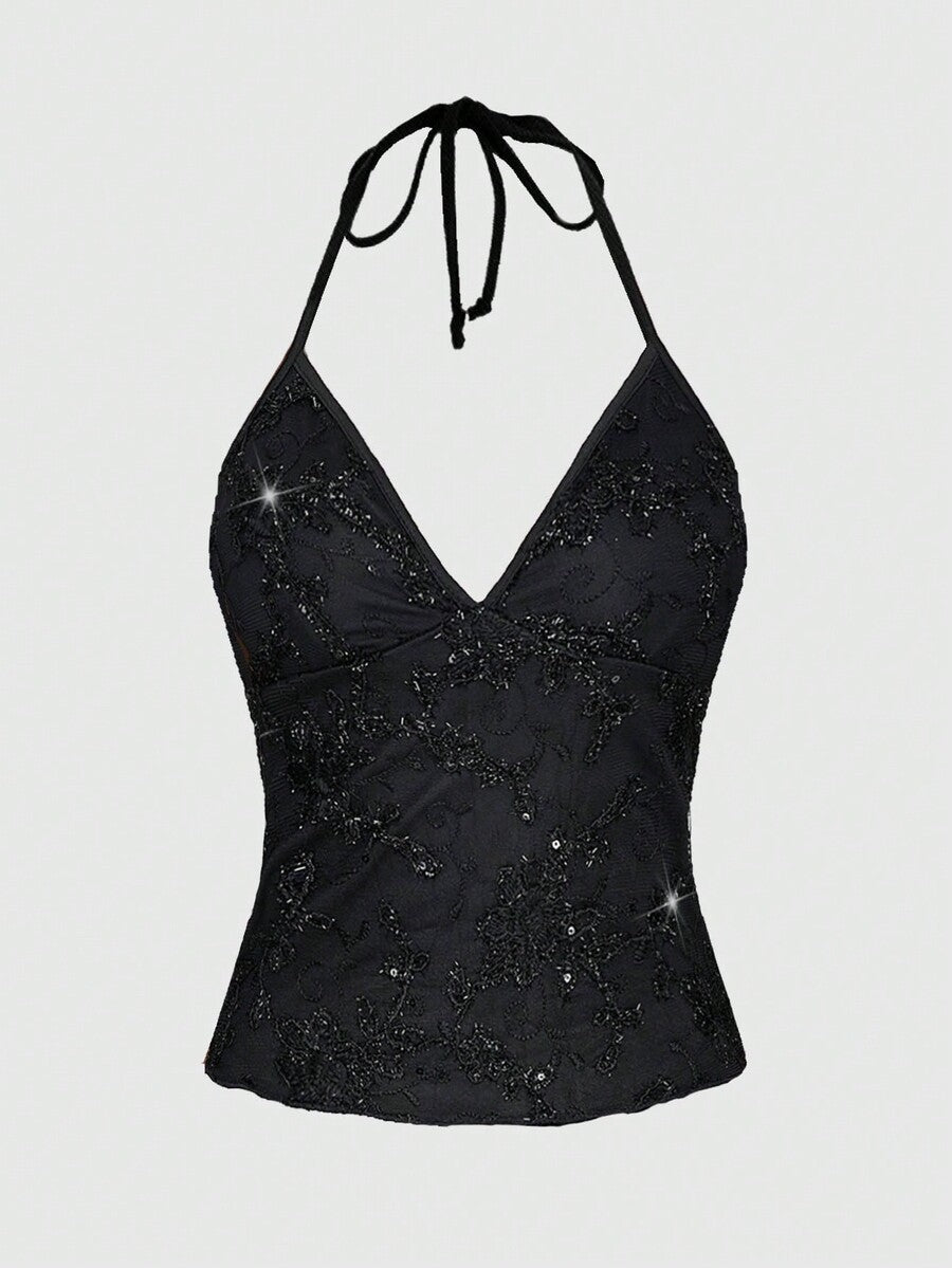 Women's black mesh sequin halter top featuring a backless design, knot details, and lace fabric.
