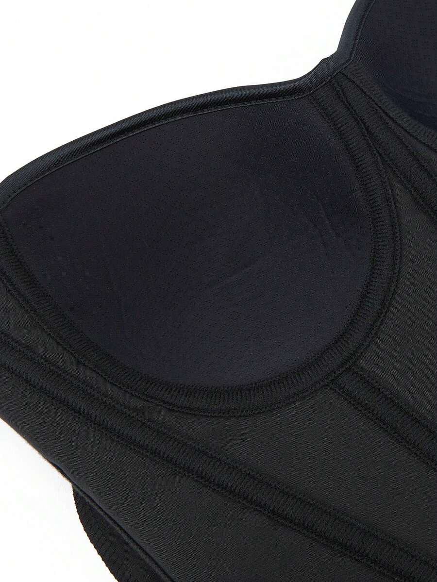 Black overbust corset top with strapless design, boned support, tie-back and zipper closure for women shapewear styling.
