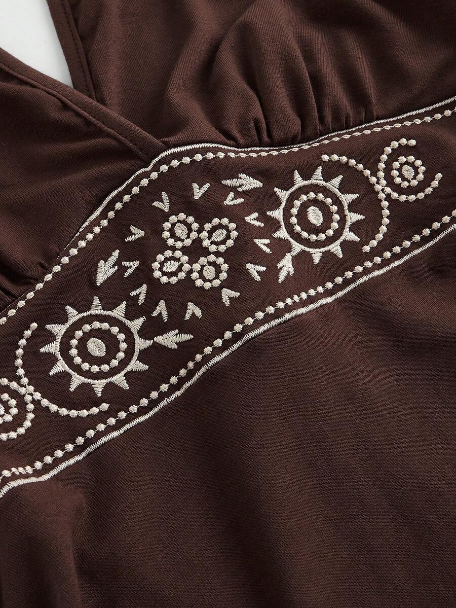 Women's sun totem embroidered sleeveless layered mini dress featuring a halter neck, backless tie back design, and slim fit high-waist A-line silhouette.