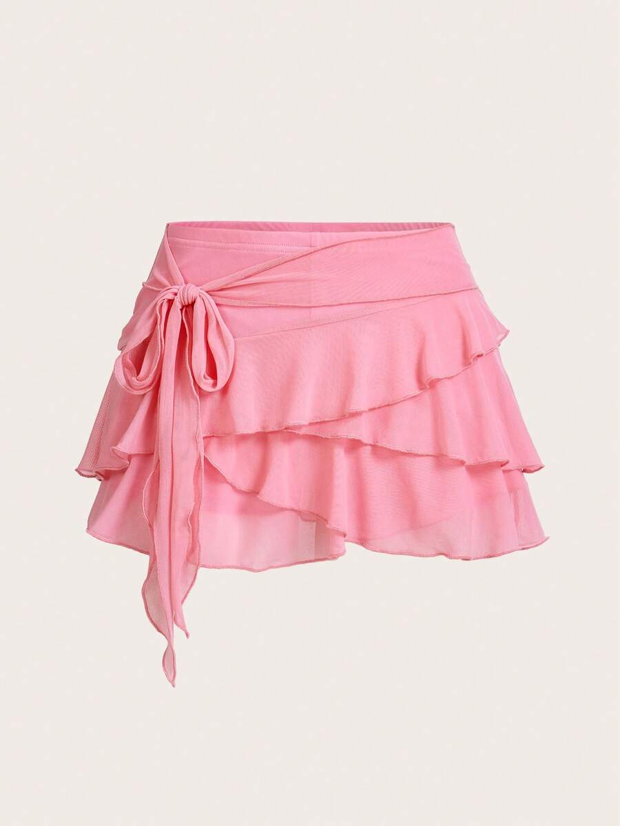 White tiered ruffle trim mini skirt for women with low waist, knot detail, mesh fabric, and casual Y2K boho design.
