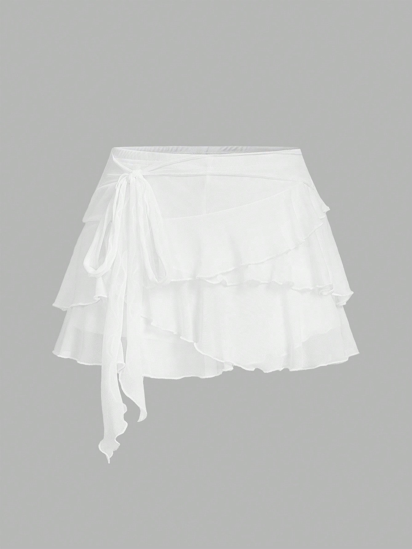 White tiered ruffle trim mini skirt for women with low waist, knot detail, mesh fabric, and casual Y2K boho design.