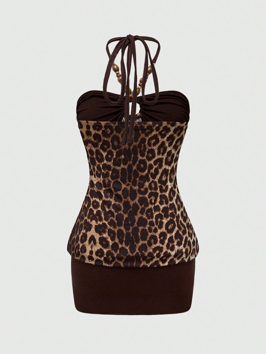 Women's black Y2K halter neck backless bodycon mini dress featuring beaded decor, textured patchwork pattern, natural waist, and slim fit pencil hem.