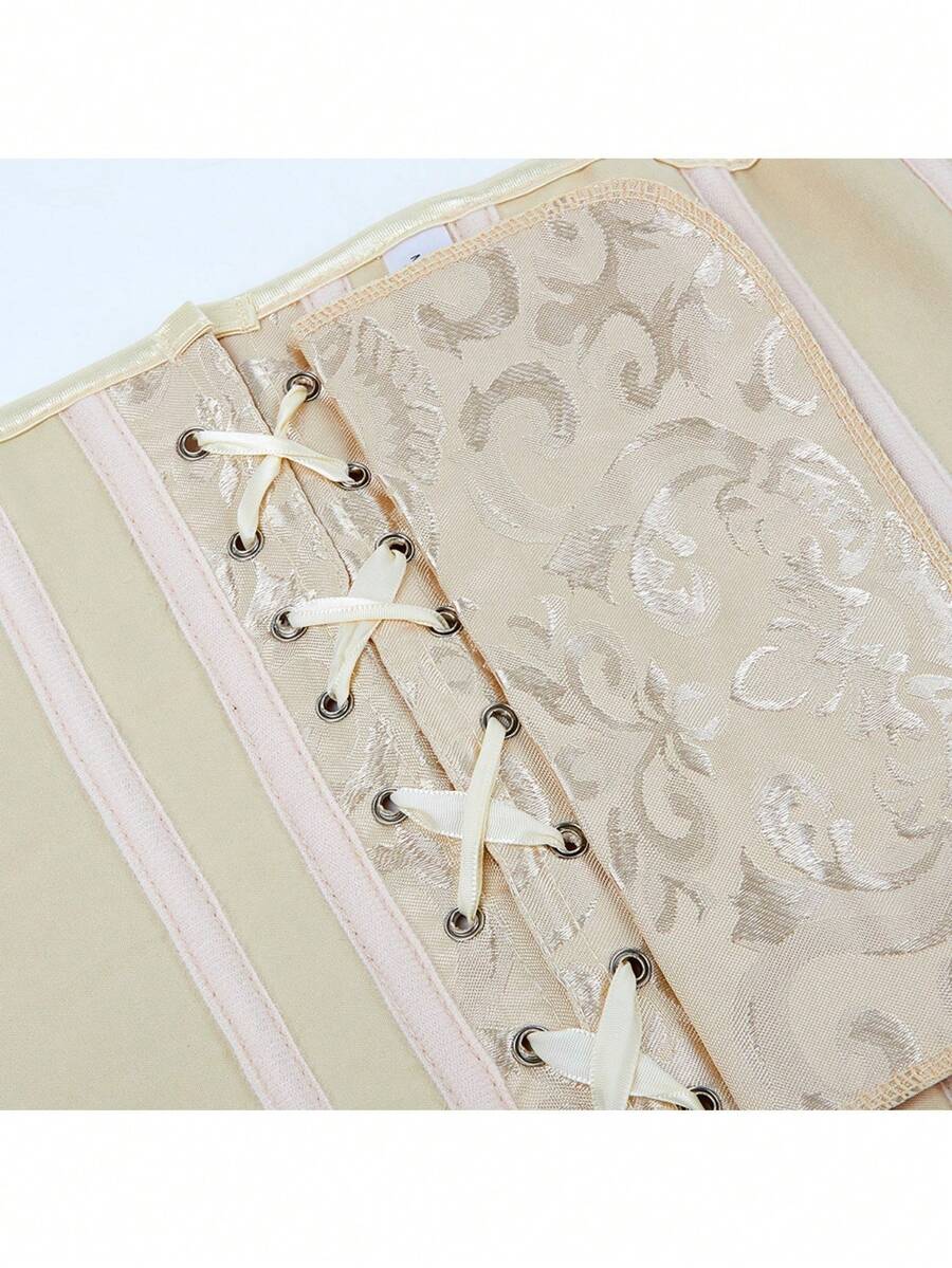 Vintage lace-up waist trainer corset with grommet eyelet details and plant pattern, designed for Halloween styling.