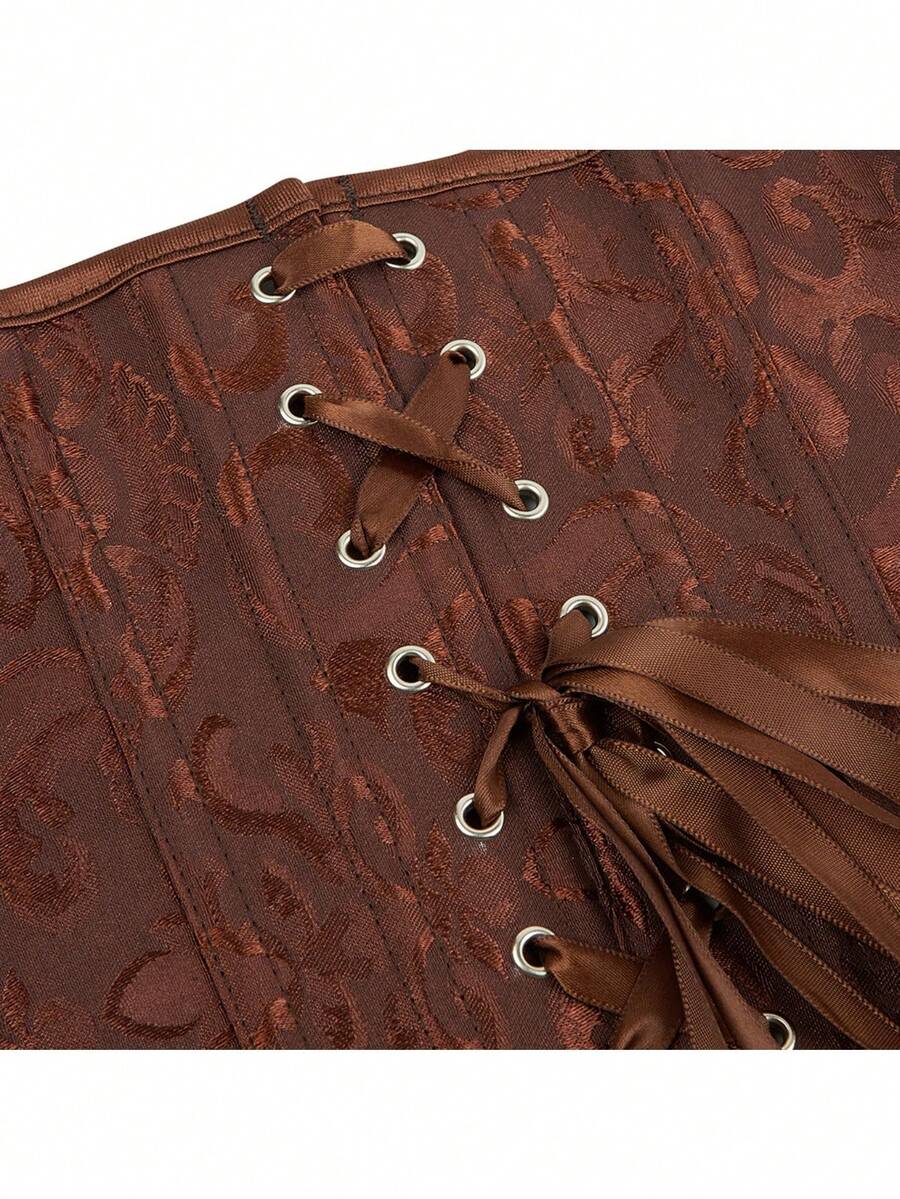 Vintage lace-up waist trainer corset with grommet eyelet details and plant pattern, designed for Halloween styling.
