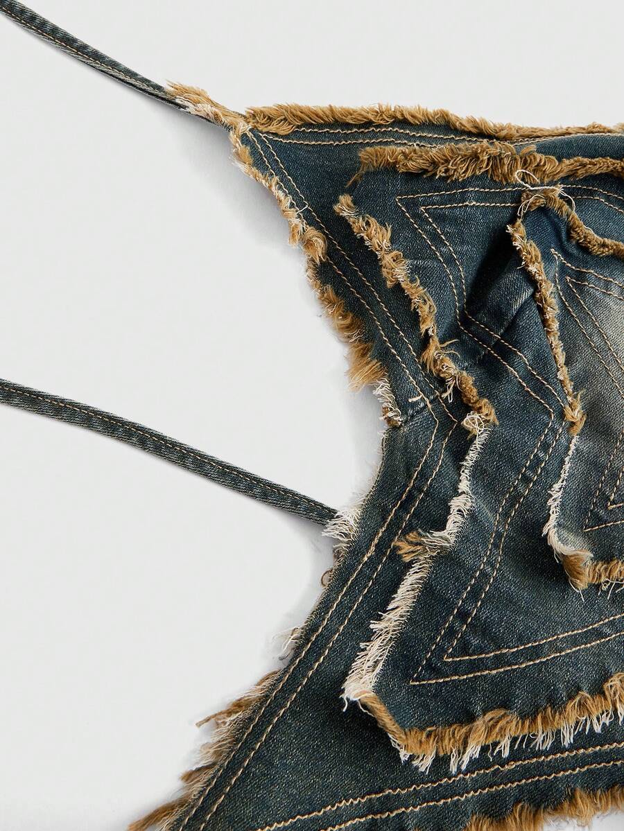 Blue denim halter tank top for women featuring distressed star patch detail, asymmetrical crop hem, and backless tie-back design.