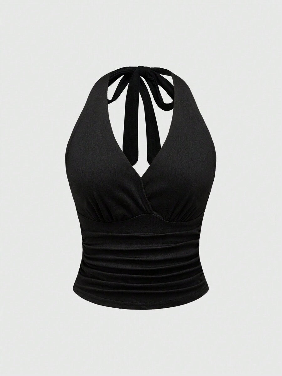 Women's halter crop tank top featuring a backless silhouette and ruched detailing in a slim fit design.