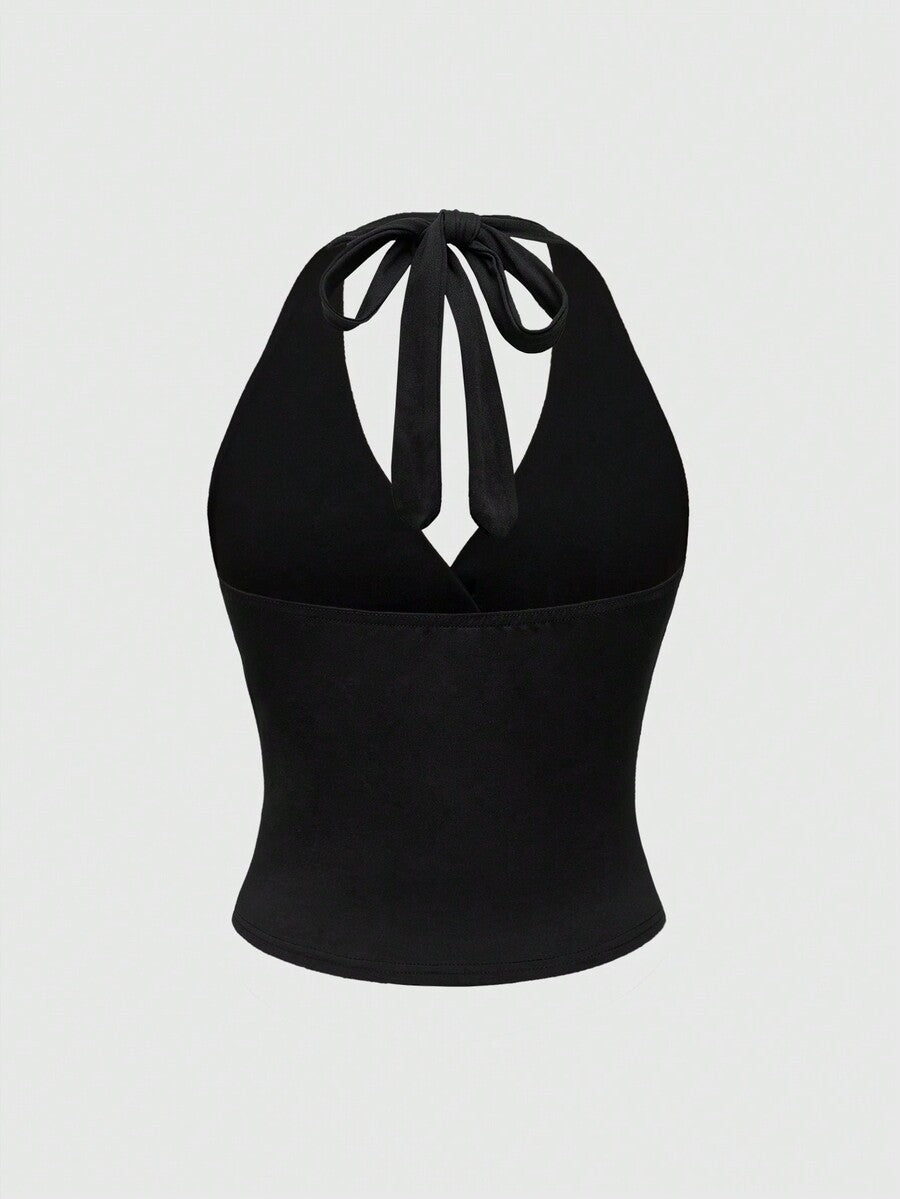 Women's halter crop tank top featuring a backless silhouette and ruched detailing in a slim fit design.