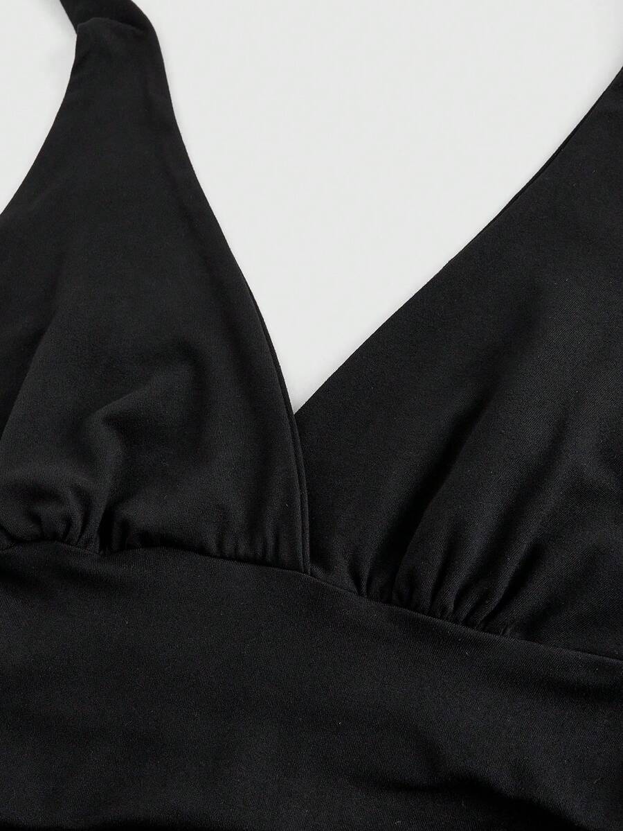 Women's halter crop tank top featuring a backless silhouette and ruched detailing in a slim fit design.