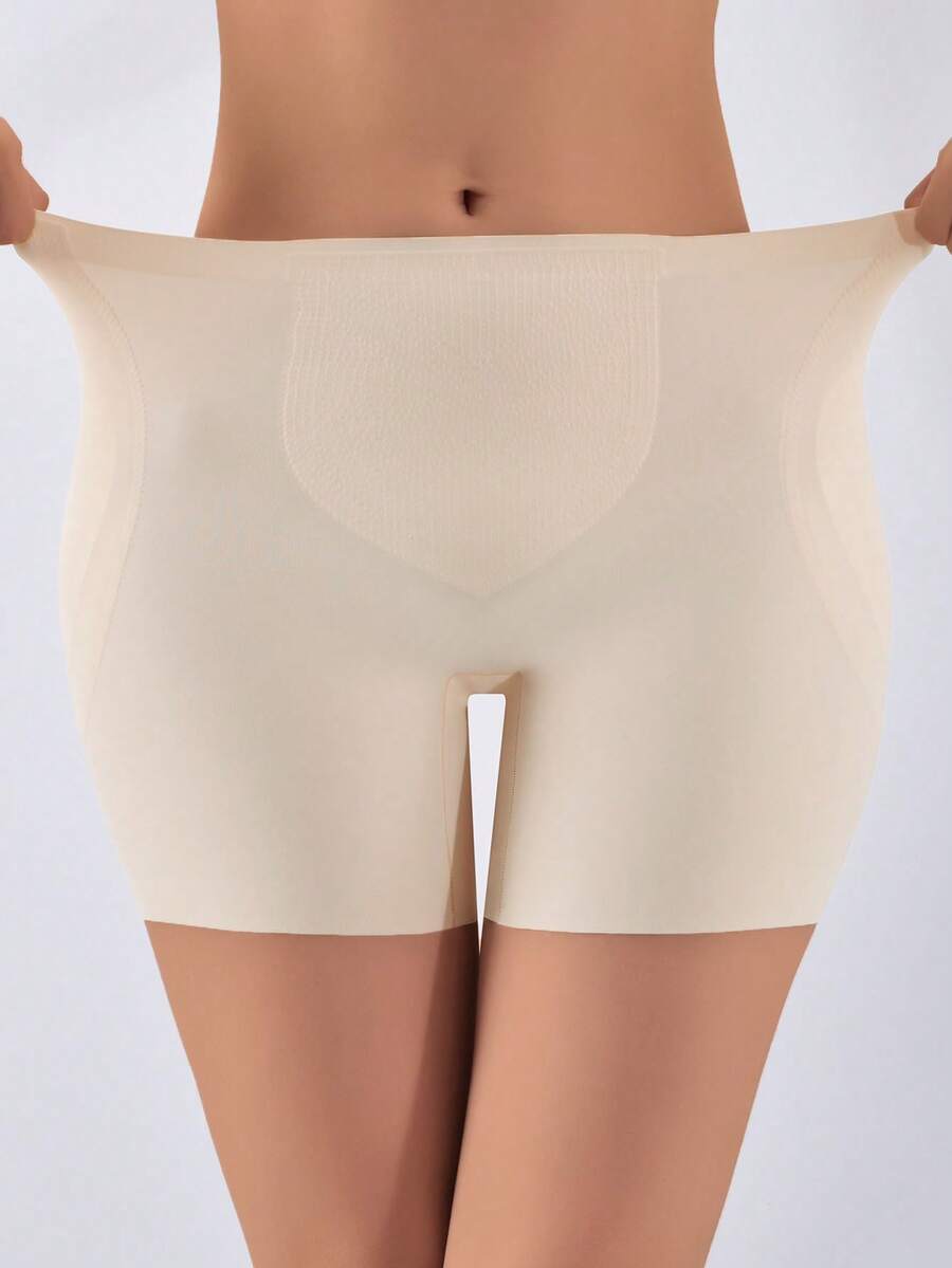 Women's apricot seamless padded shapewear panties featuring tummy control design and teardrop foam padding.