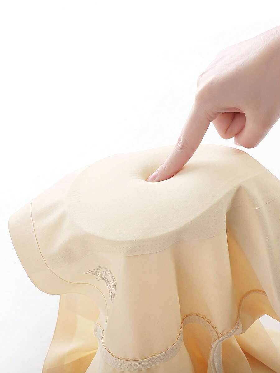 Women's apricot seamless padded shapewear panties featuring tummy control design and teardrop foam padding.