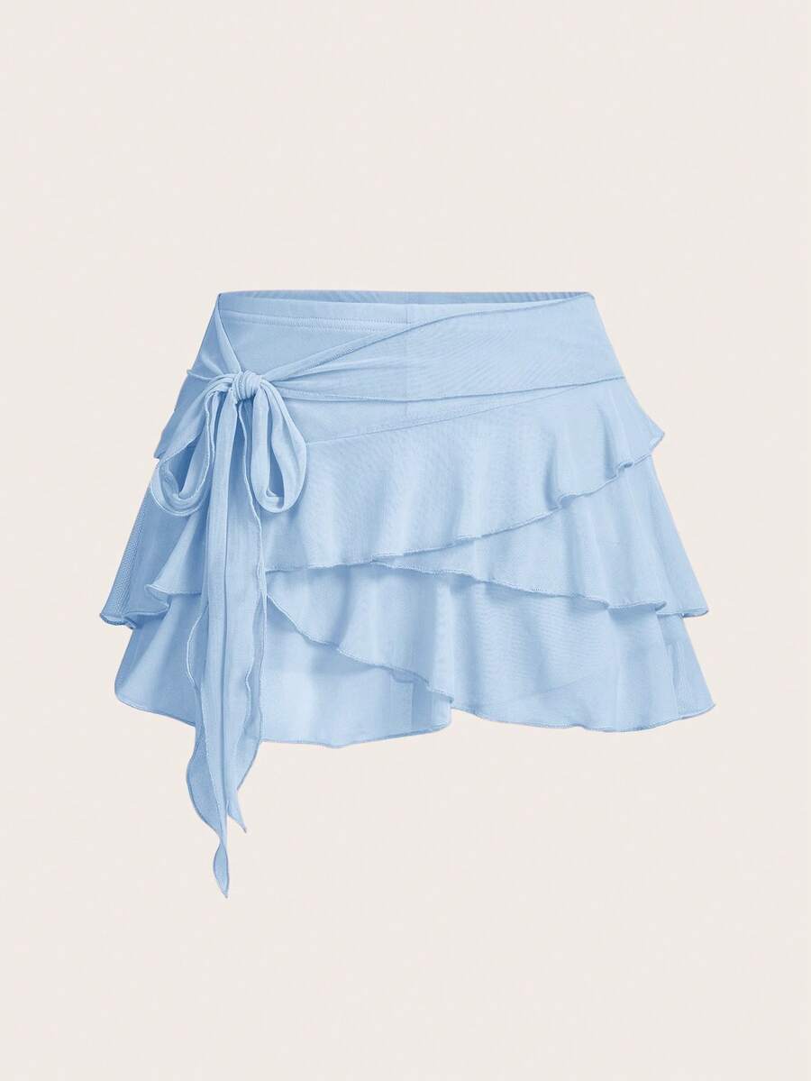White tiered ruffle trim mini skirt for women with low waist, knot detail, mesh fabric, and casual Y2K boho design.