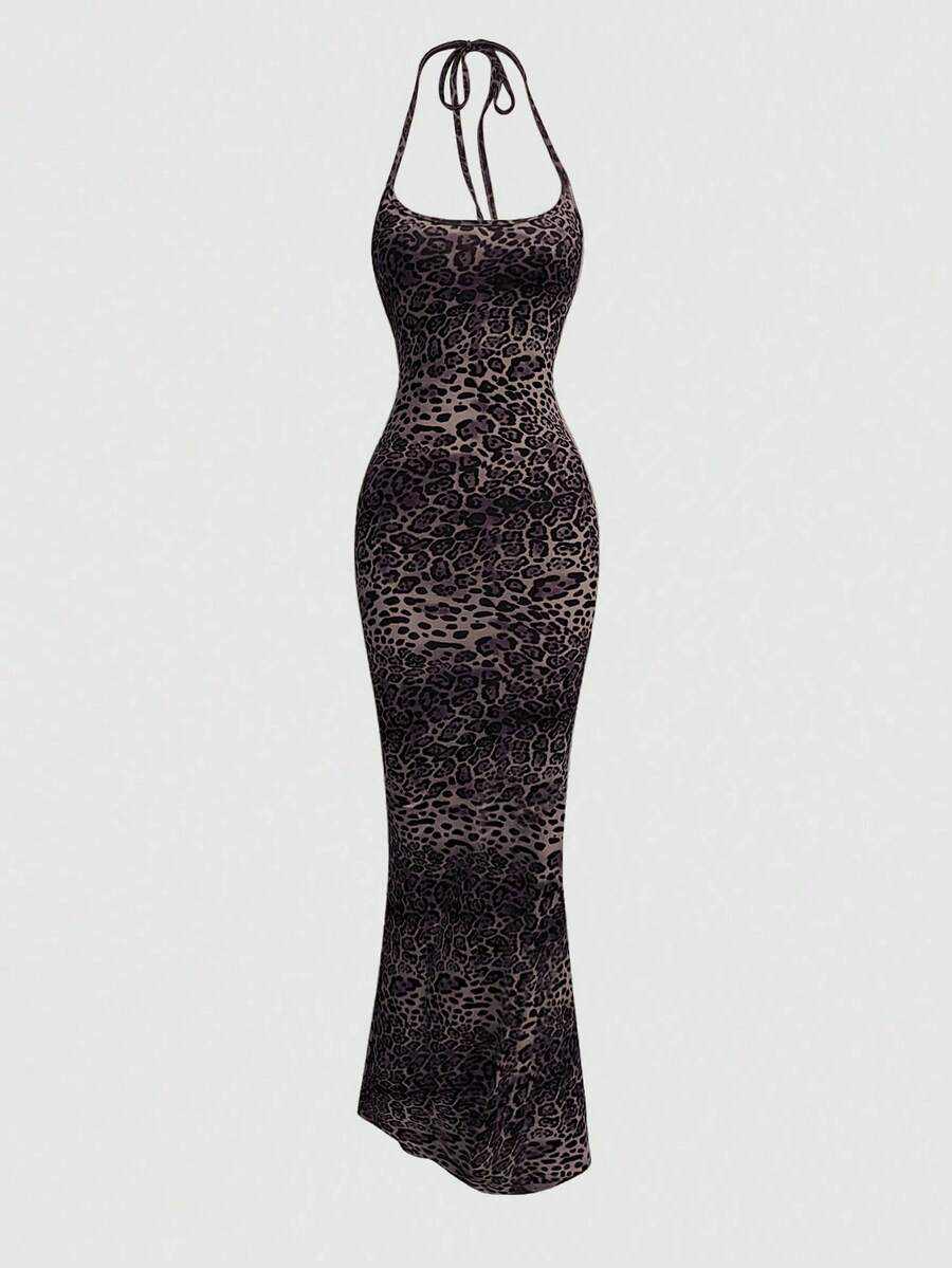 Women wearing a sleeveless leopard print halter neck maxi bodycon dress with a side slit