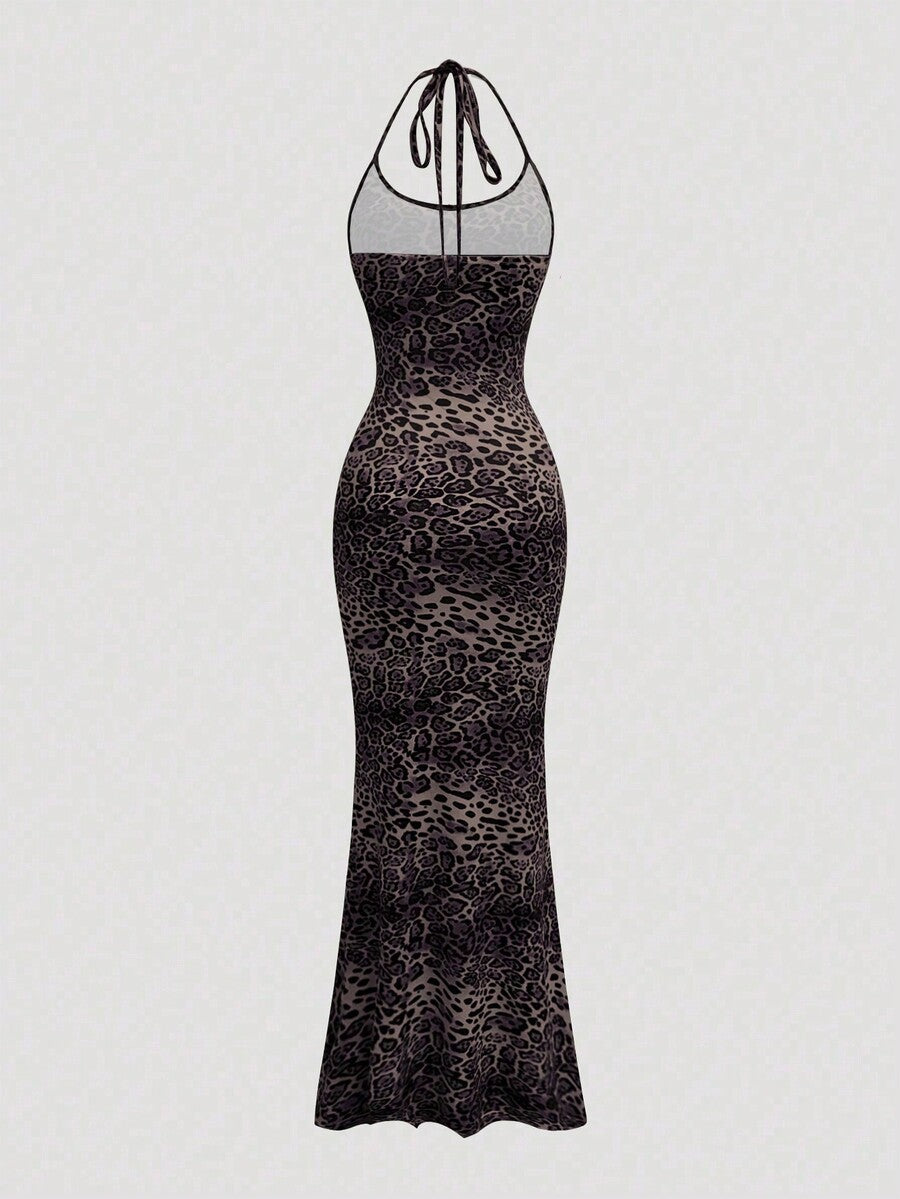 Women wearing a sleeveless leopard print halter neck maxi bodycon dress with a side slit