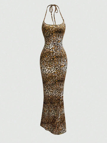 Women wearing a sleeveless leopard print halter neck maxi bodycon dress with a side slit